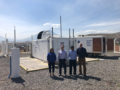 group of 4 people standing in front of the TLRS-3 station in Arequipa, Peru,
