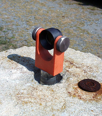 A close-up view of a corner cube mounted on one of the calibration piers used by the SLR systems at GGAO.