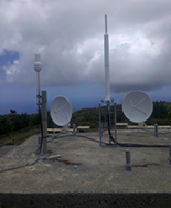 The DORIS remote control (left, foreground) and beacon (right, foreground), with VLBI antennas in the background (2010)