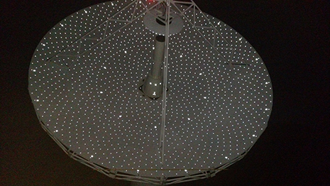 An after-dark closeup of the main reflector shows the targets used for photogrammetry. 