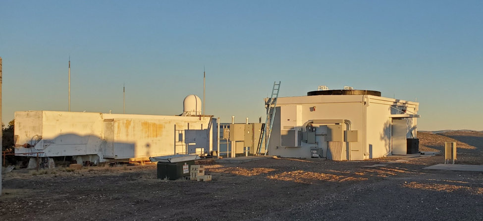 >SGSLR shelter (building to the right) before the dome installation.  The black dome ring wall can clearly be seen atop the SGSLR shelter.  The legacy MLRS SLR system with its radar on top is to the left in the picture.