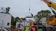 The dome is lifted onto the shelter