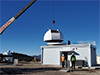 Crane lifting dome on top of the shelter at MGO